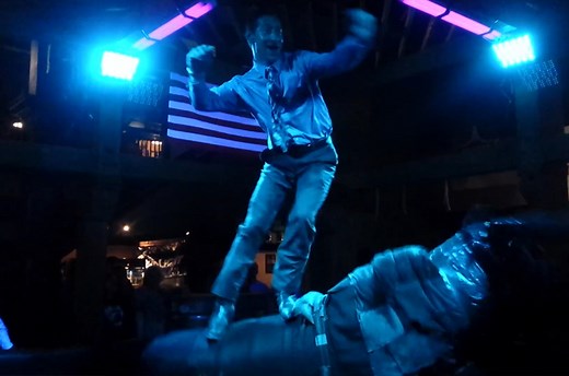 Cowboy dances on a mechanical bull while looking dapper as hell