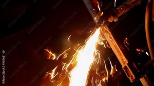 A close up of a welding process showcases bright sparks and intense motion, emphasizing craftsmanship and industrial energy