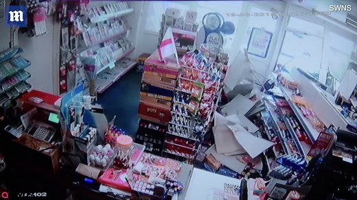 Shocking moment car crashes through shop front window