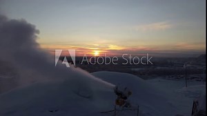 A snow cannon is blowing snow at the ski resort