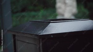 Black metal trash bin in the park