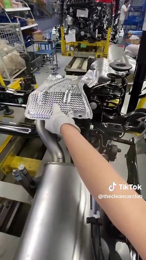 Exhaust Heat Shield Installation in Car Factory
