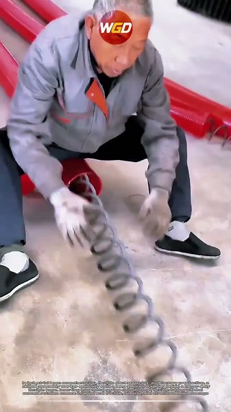 Hand-coiling technique for inserting long steel springs into flexible hoses