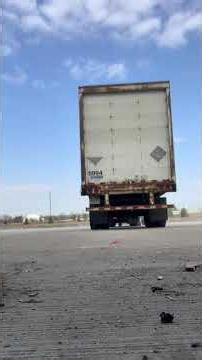 “Tractor trailer backing big empty yard (dock view).”