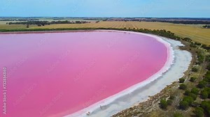 Footage Aerial view of Dimboola pink lake Nature Reserve of western Victoria, Australia, the Pink Lake gets its vibrant colour from a salt tolerant alga living in the salt crust.