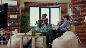 Diverse people getting scared watching horror movie on television program, having terrified reaction after looking at scary film. Afraid shocked friends covering eyes and doing jump scare.