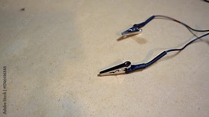 Alligator clips used to send electrical current into metal artifacts or tools for electrolytic cleaning.