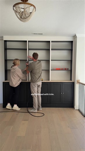 IKEA built-ins DIY Pt 2 🔨 Go back and watch pt 1 if you missed it!! This is the easiest way to do built-ins EVER and will save you thousands. We used: 3 IKEA Havsta cabinets for lowers, a 3/4” finished plywood top, and 3 standard Billy bookcases (cut down to fit our 8ft ceilings). Next we secured the pieces to one another, anchored the shelves to studs in the wall, and trimmed everything out using a 1x6 header ( crown molding) and 1-1/2” primed pine lattice molding. Now we’re filling holes and 