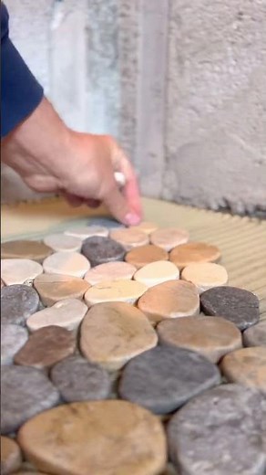 Installing a pebble shower floor #diy #tiling #howto #tile #construction #riverrock #pebbles