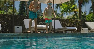 clip-1077095450-kids-jumping-into-pool-on-summer-vacation