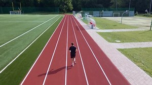 Man running at race track. Sport man training at stadium.