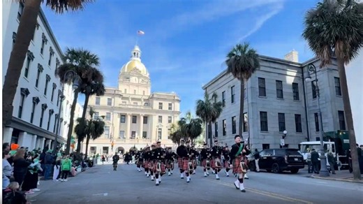 The parade passes Savannah City Hall.