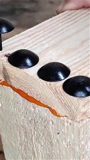 the process of forming a wooden elbow using glue and thumbtacks