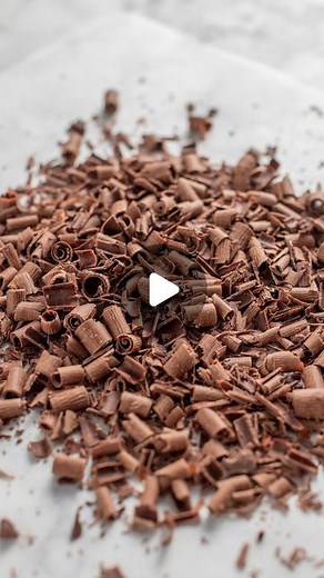 Nick Makrides on Instagram: "This week I spent some time testing out the easiest way to make chocolate curls at home. These are a one ingredient/tool tutorial and are such a great way to decorate desserts! Put them on mousse, cover cakes with them or sprinkle them on cupcakes! All my tips are on my blog. 🍫 Google 'Scran Line Chocolate Curls' for the recipe!"