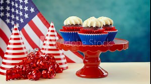 Red white and blue theme cupcakes with USA flags for Independance Day or USA theme party food.