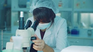 Woman scientist microscope research. Female scientist looking microscope. Lab scientist looking through microscope. Science laboratory research. Lab technician using laboratory microscope