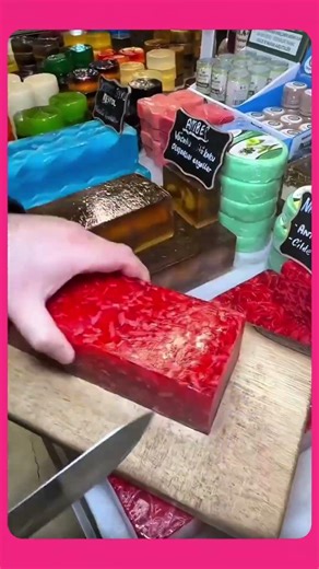 A colorful layered jelly block with bright spiral patterns, neatly sliced into even pieces