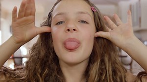 Premium stock video - Funny girl making faces at camera