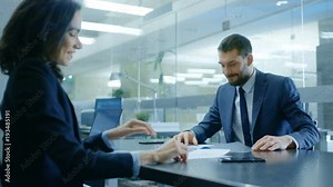 Businesswoman and Businessman Have Conversation. Draw up a Contract, Sign Documents, Seal the Deal, Finish Transaction, Come to an Agreement. Shot on RED EPIC-W 8K Helium Cinema Camera.