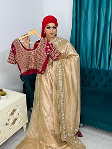 Combination of ivory gold and blood maroon,featuring a perfect pair of elegance and royalty.Giving a makeover to the bestseller ivory hand crafted pure tissue saree with a blood maroon hand Zardosi pure raw silk blouse. | OSHIN