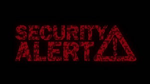 Premium stock video - Classic animated security alert message with warning sign with animated binary code texture in red color scheme on a black background