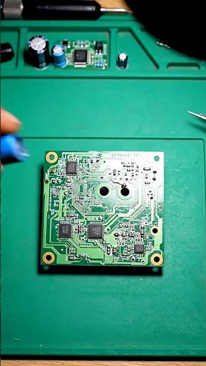 electronics repair, technician hands removing swollen capacitor from PCB and replacing with new one