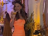 Miranda Kerr living it up in an orange gown at an event for her beauty line