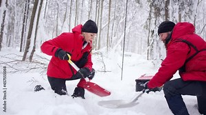Mountain rescue service on operation outdoors in winter in forest.