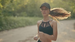 Slow motion of a girl running outdoors  - Free Stock Video