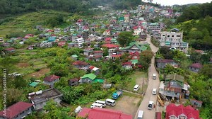 The town is surrounded by mountains, a top view. Sagada city on Luzon island, Philippines. Houses and streets of a mountain town. Village in Cordillera mountains. Stock Video