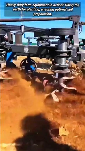 ​High-speed rotary tiller vigorously preparing the farm field.