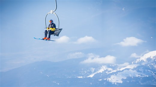 Skydiving with snow skis.