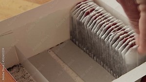 A man taking a tea bag out of a box
