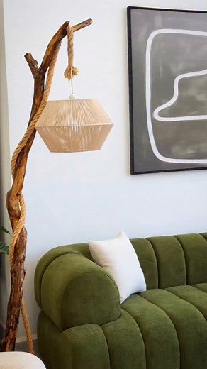 This L-shape sofa features a modern, sculptural design with deep channel-tufted sections that create a bold, luxurious look. Upholstered in a rich olive-green fabric, it brings warmth and elegance into the room while maintaining a soft, cozy feel. The rounded cushions and low-profile silhouette make it incredibly inviting, perfect for relaxing or lounging. Its extended chaise section provides extra comfort and seating space, making it ideal for large living areas. Paired with minimal décor and n