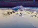 Amazing footage shows wave breaking ice on frozen lake
