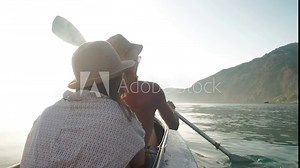 Travel couple kayaking together explore sea during honeymoon. Back view of a young couple in love on a boat in the sea at sunset. Y Happy man and woman travel in summer. Stock Video