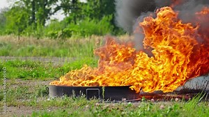 Intensity of fire. Flames erupt from manhole cover, creating striking contrast against lush green surroundings. Moment captures unexpected burst of fire in nature. Slow motion in 4K, UHD