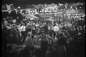 Wide shot of people dancing at state fair, 1940s.