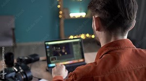 Photographer processing photos in a program using a laptop, laptop photo screen photography.