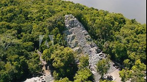 Aerial view of Ancient Mayan pyramid and Coba ruins in Mexico. Landscape panorama of Quintana Roo Peninsula from aboveL. Lush jungle on a sunny day, 4k UHD.