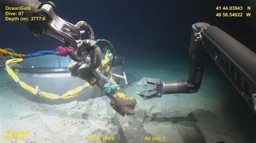 See the robotic arms of an ROV gather pieces of Titan submersible from the ocean floor