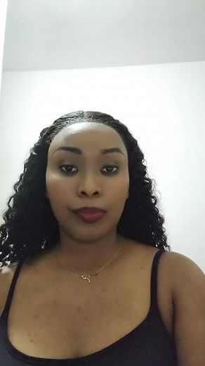 Person with Curly Hair in Black Tank Top