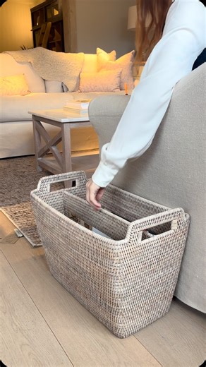 Trevor Morrow on Instagram: "This magazine basket, crafted from durable rattan, features a tall, slim design perfect for placing beside your sofa or armchair. It boasts a central divider and handles on each end. The washed enamel finish gives it a modern look. Keep your books handy for a cozy reading session."