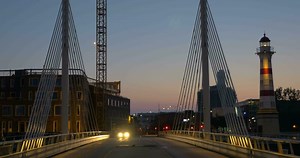 Car driving over the bridge at night