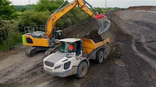 Perfect teamwork between a massive excavator and dump truck
