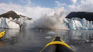Watch a giant glacier collapse in front of two kayakers