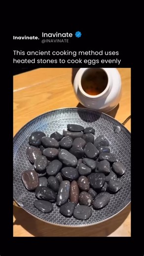 Inavinate on Instagram: "Eggs cooked in hot fried gravel rely on pure heat transfer rather than a pan or oil. The gravel is heated over an open flame until it reaches extremely high temperatures, storing thermal energy across thousands of small stones. When an egg is buried inside, the heat transfers evenly from all sides through conduction, cooking the egg without direct flame contact. The shell protects the egg from burning while the intense, surrounding heat rapidly sets the whites and cooks