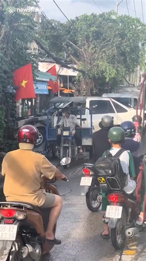 Tiny tricycle carries a car on the back through narrow street | The Laugh Lab | Facebook
