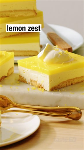 18K views · 68 reactions | Scotch Finger biscuit base, cheesecake filling and lemon custard jelly top . Recipe >> https://www.taste.com.au/recipes/lemon-lush-squares-recipe/y5br1qc8 | Taste.com.au | Facebook