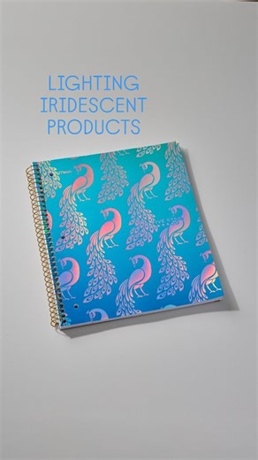 The iridescent effect is actually caused by microscopic structures etched into the foil. Those structures reflect and refraction light in a very unique way. Even though it's technically a reflection, filling the reflection with light hides the color effect caused by those little structures. Moving the light to the side but still pointed directly at the surface, allows the colors to show from all the refracting light without being offiscated by the reflecting light. So to make iridescent surfaces